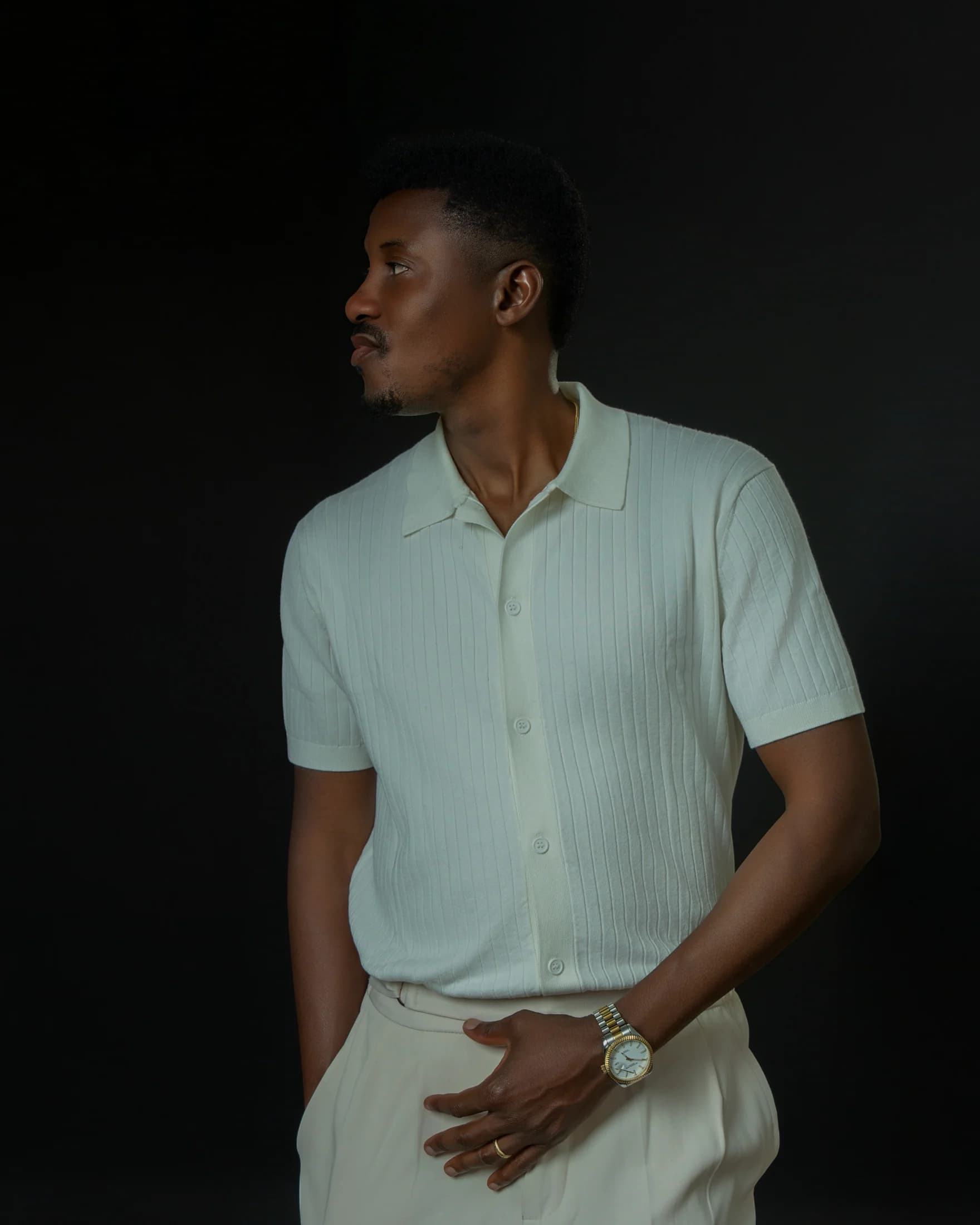 Profile portrait of Philip Akinjobi in an ivory knit shirt